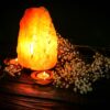 himalayan sal lamp li with candle and flowers
