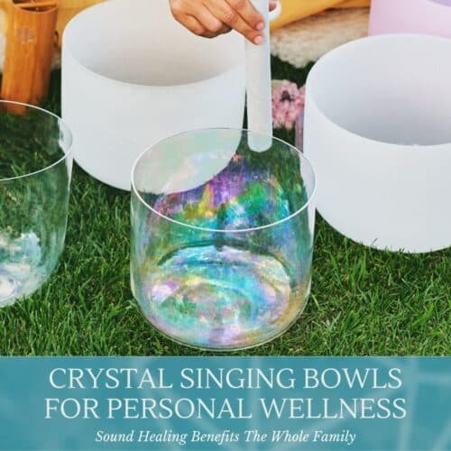 hand playing crystal singing bowls on grass saying crystal singing bowls for personal wellness class at the om shoppe and spa