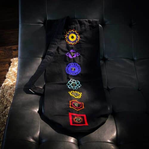 black yogal mat bag with 7 charka embroidered sanskrit symbols for sale at the om shoppe