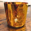 6 Inch Gold Alchemy Hand Inlaid Crystal Singing Bowl on table with bells and a quartz crystal triagnle for sale at the om shoppe