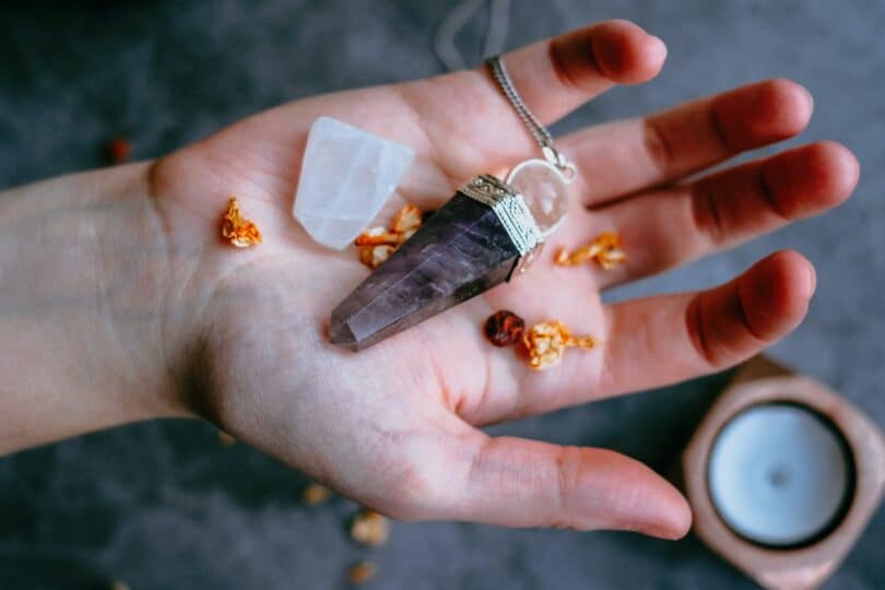 holding crystal to charge it in hand